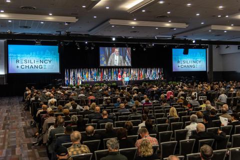 Convention presentation in auditorium, guests in audience